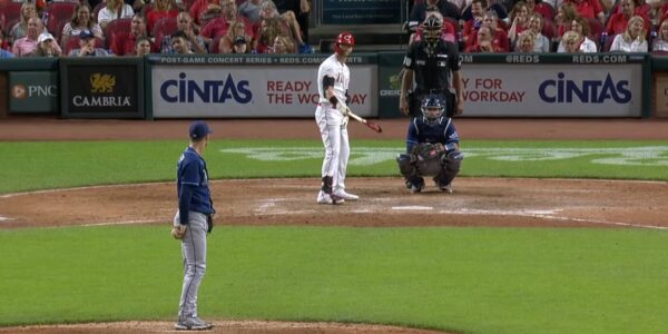 A pitcher facing a batter in a baseball game with spectators in the background