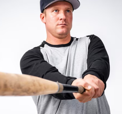 Close-up of a baseball bat with a player