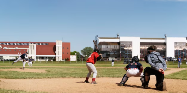 Side view of kids playing baseball outdoors