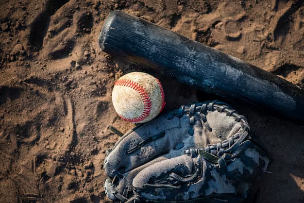 Baseball bat, ball and glove on the sand