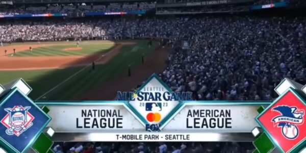 A crowded stadium in Seattle, with National and American League logos