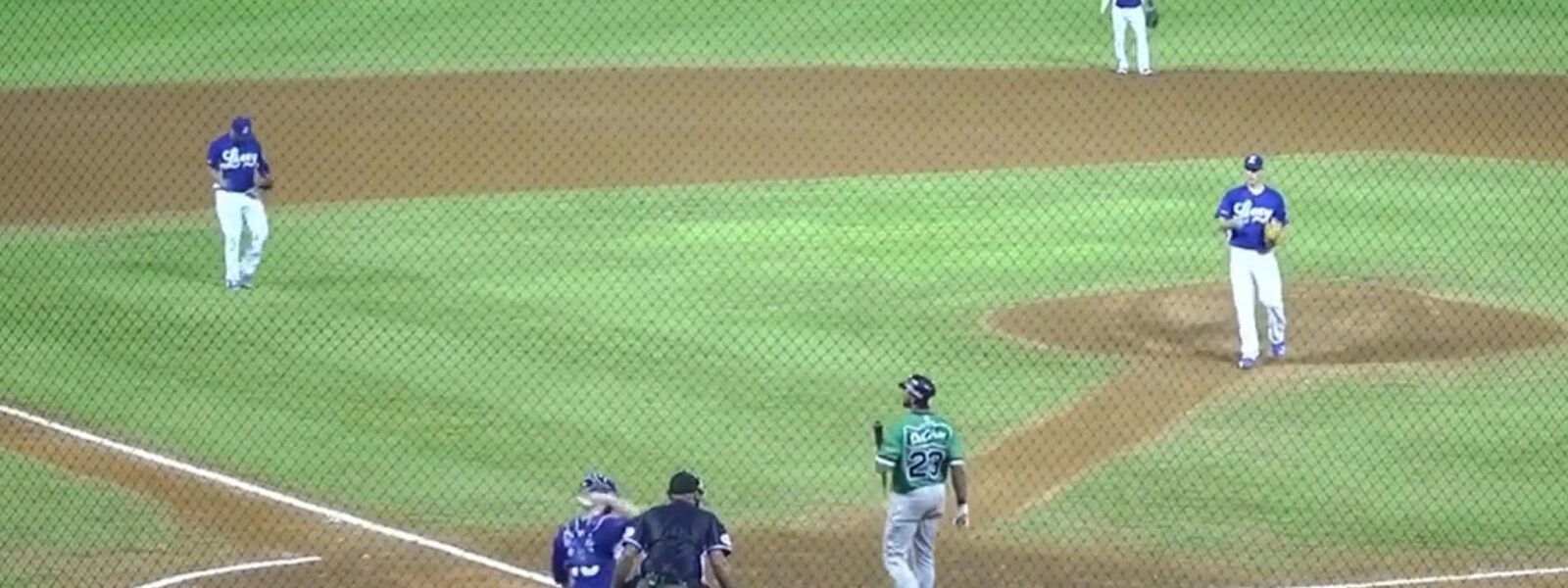 A baseball game in progress with the pitcher preparing to throw to a batter in a green jersey