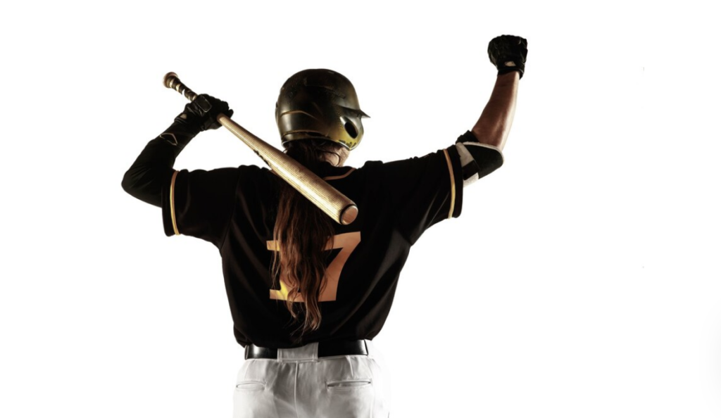 Silhouetted batter in black uniform holding a baseball bat